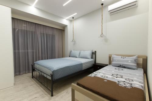 Pokój z 2 łóżkami i oknem w obiekcie Vila SHAKAJ w Sarandzie