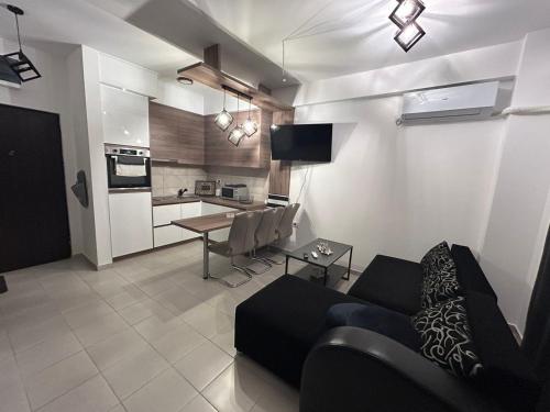 a living room with a couch and a table at Matic Apartmani 4 in Trnava