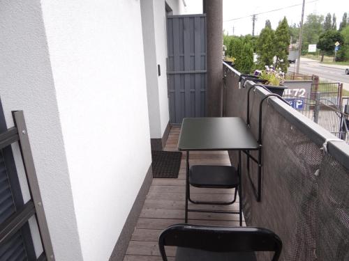 a table and two chairs on a balcony at Hotel Apartamenty 72 in Płock