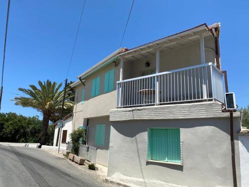 a building with a balcony on the side of a street at Spitaki in Polis Chrysochous