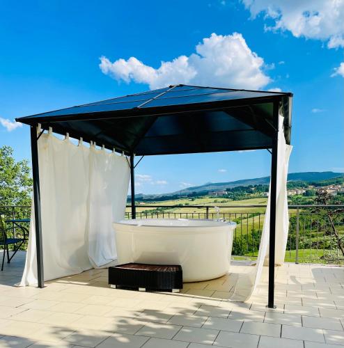 a gazebo with a bath tub on a patio at Arts Club Suite & Spa in Chianciano Terme