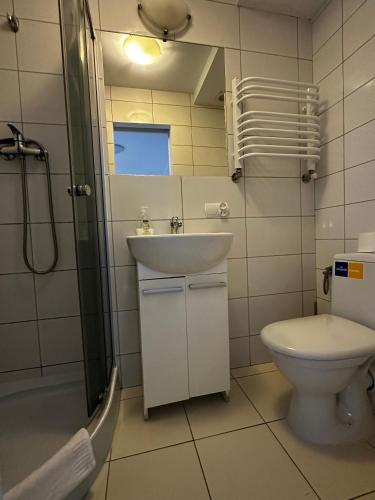 a bathroom with a sink and a toilet and a shower at Pensjonat Jagoda B&B in Międzyzdroje