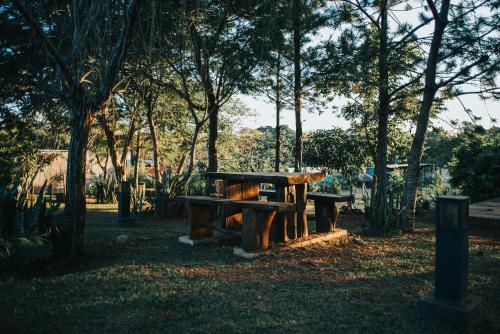 a picnic table in a park with trees at Irová Apart Hotel in Posadas