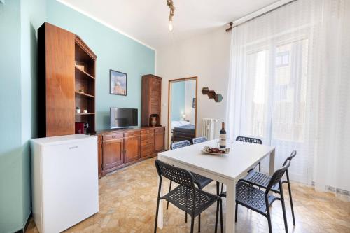 a kitchen and dining room with a white table and chairs at We Home - SANLUCA57, Bologna in Bologna