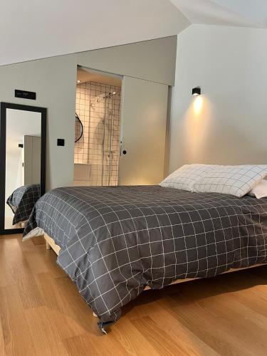 a bedroom with a bed with a gray blanket at Morgado da Granja in Aveiro