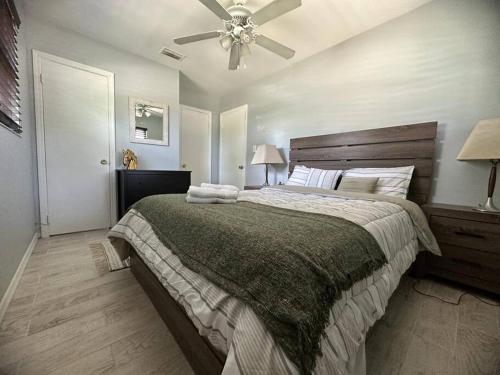 a bedroom with a large bed with a ceiling fan at Minutes away from Clearwater beach in Clearwater