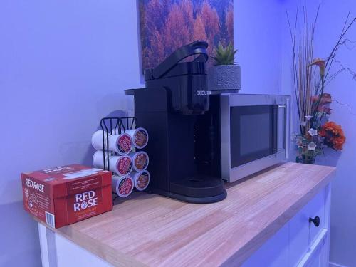 a coffee machine sitting on a wooden counter with a box at Fully Furnished CozyTwo Bedroom in Winnipeg