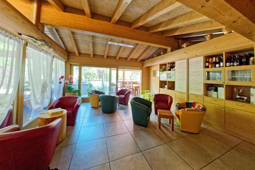 a restaurant with chairs and tables in a room at RTA Hotel Le Vallene in Terlago