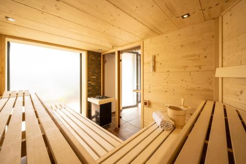 a wooden cabin with a bench in a room at Ferienwohnungen Assenmacher mit Sauna in Altenahr