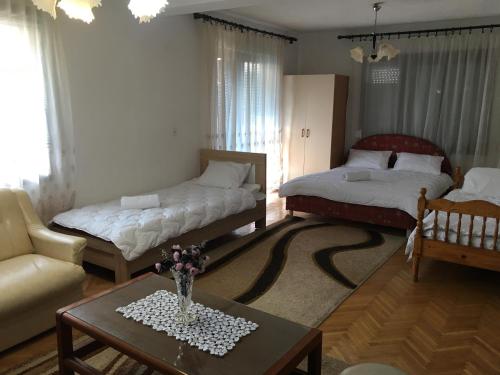 a living room with two beds and a coffee table at Apartman Struga in Struga