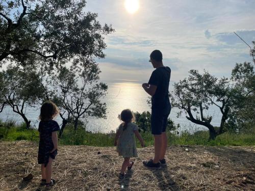 a man and two little girls standing next to a man at Farm seaview on Capri in Termini