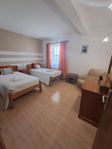 a large room with two beds and a couch at Vila Flor in Lajes das Flores