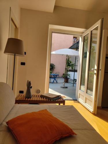 a bedroom with a bed and an open door to a patio at Casa Pellico in Turin