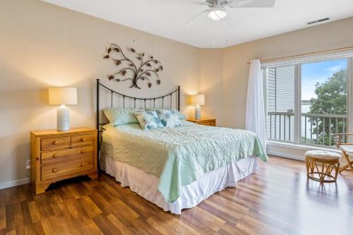 a bedroom with a bed and a balcony at Regatta Retreat in Lake Ozark