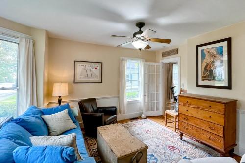 a living room with a blue couch and a ceiling fan at Camden 1865 in Camden
