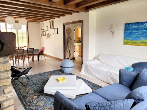 a living room with a couch and a table at Casateja Houlgate in Houlgate