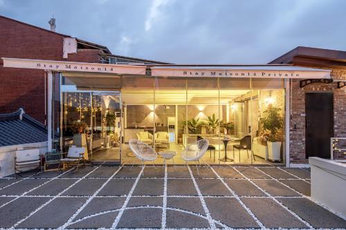a building with a patio with chairs and tables at Jeonju Hanok Village, Maison14 in Jeonju