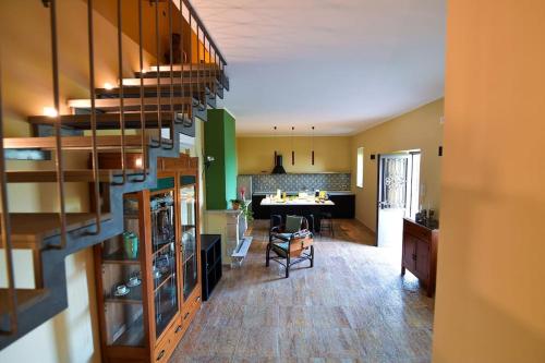 a kitchen and living room with a staircase in a house at La Riggiola in Salerno