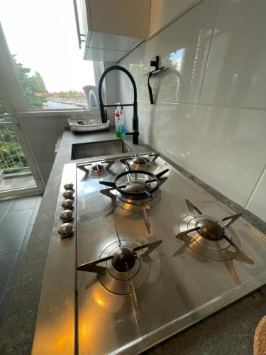 a stove top with three burners in a kitchen at Sunny and spacious apartment in Rotterdam