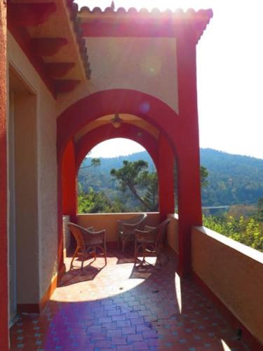 an archway with chairs on a balcony with a view at casabelladona Barcelona in Barcelona