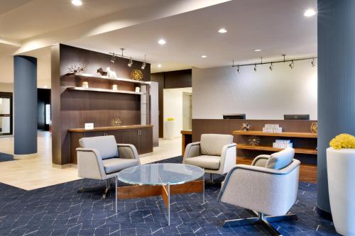 a waiting room with chairs and a table at Courtyard by Marriott Houston NASA Clear Lake in Nassau Bay