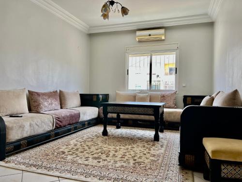 a living room with a couch and a table at Cozy Apartment in Salam center in Agadir