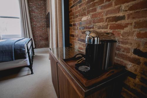 a wooden desk with a hair dryer on it next to a brick wall at Historic Jacksonville Inn in Jacksonville