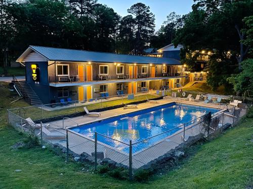 a house with a large swimming pool in front of it at The Wanderoo Lodge in Eureka Springs