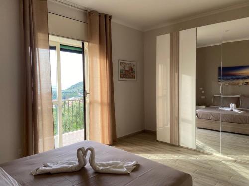 a bedroom with a swan on a bed with a window at Casa di Nonna Gilda in Massa Lubrense