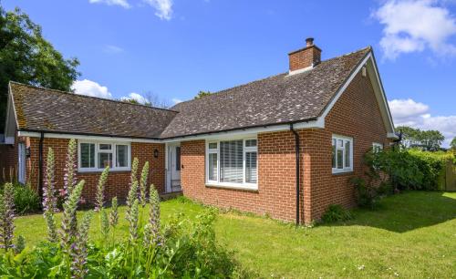 a red brick house with a grass yard at APPLEDOWN - Secluded Rural Retreat in Kingsdown, 10 mins to BEACH in Kent