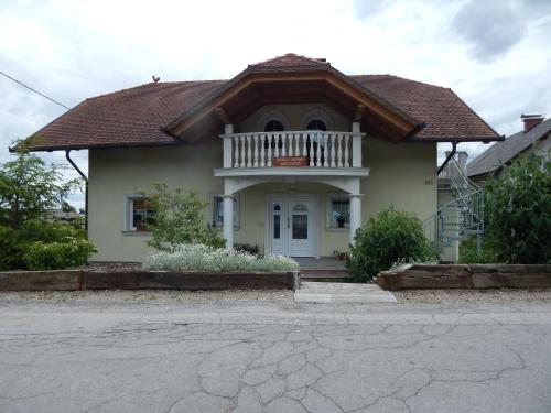 a house with a porch and a balcony at Rooms Ambrožič in Bled