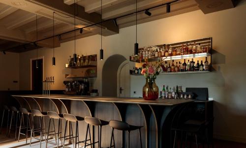 a bar with a row of stools in a room at Blyb Hotel in Gmund am Tegernsee