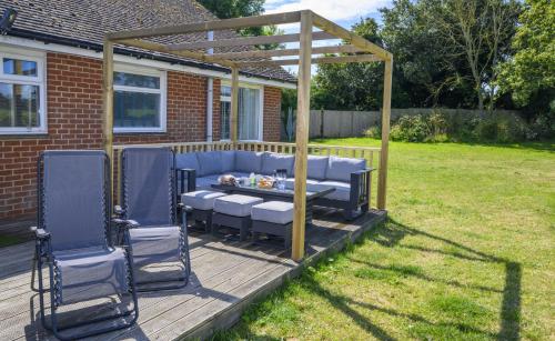 a pergola and a table and chairs on a deck at APPLEDOWN - Secluded Rural Retreat in Kingsdown, 10 mins to BEACH in Kent
