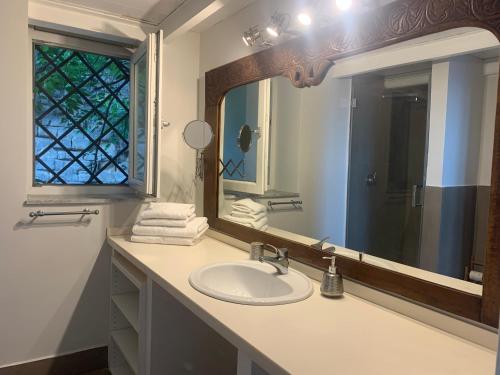 a bathroom with a sink and a large mirror at MARE DI NAPOLI in Pozzuoli