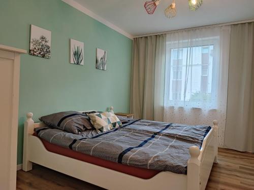 a bedroom with a bed and a window in it at ablotu - 2-8 person, parking,garden in Świnoujście