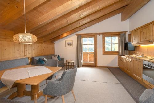 a kitchen and dining room with a table and chairs at Gästehaus Larch in Alpbach