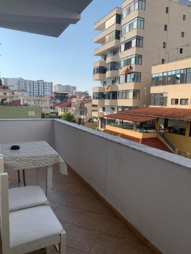 a balcony with a table and chairs on a building at ELIO's Room in Durrës