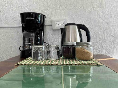 a counter top with a coffee maker and a coffee pot at Apartment located two blocks from the sea in Cozumel