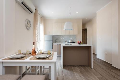 a kitchen with a table with two plates on it at Morfeas by Anita Holiday Homes in Agios Rokkos