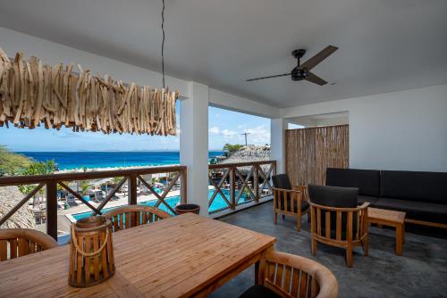 a dining room with a table and a view of the ocean at Bloozz resort Bonaire in Kralendijk