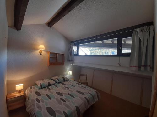 a bedroom with a bed and a window at Duplex 6 personnes, VARS LES CLAUX, Skis aux pieds in Vars