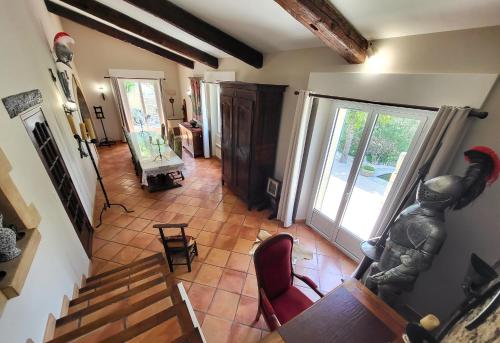 eine Draufsicht auf ein Wohnzimmer mit einer Treppe und einem Zimmer mit einem Kamin in der Unterkunft "La Massette du Cheval Blanc" Villa de caractère en pierre in LʼIsle-sur-la-Sorgue