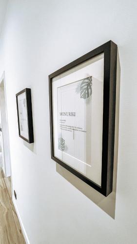 a picture hanging on a wall in a room at Casa Monuriki in Rapallo