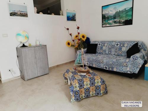 a living room with a couch and a table at Casa Belvedere in Portopalo
