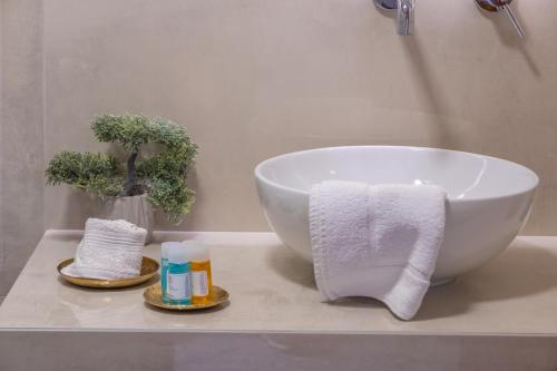 a bathroom with a bowl sink and towels on a counter at Rousis Studios in Parga