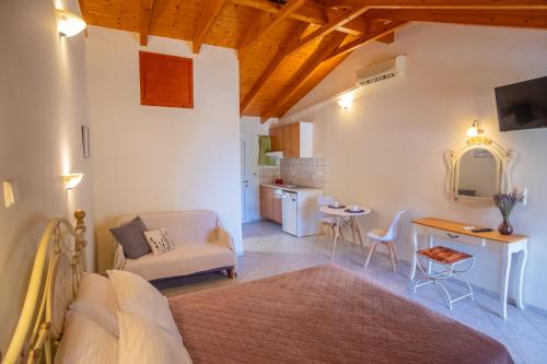 a living room with a bed and a table at Rousis Studios in Parga