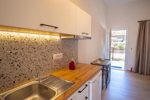 a kitchen with a sink and a counter top at Rousis Studios in Parga