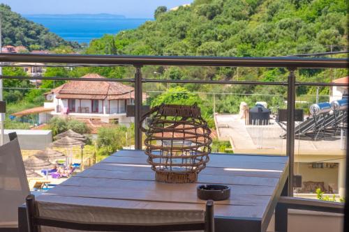 a table on a balcony with a view of the ocean at Rousis Studios in Parga