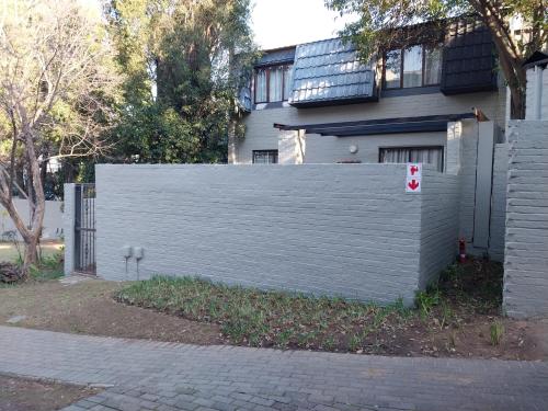 a white privacy fence in front of a house at 42 Avignon in Johannesburg