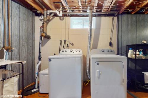 a laundry room with two washer and dryers in it at Magnolia Place in New Buffalo